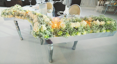 Lush floral displays surrounding the couple's sweetheart table