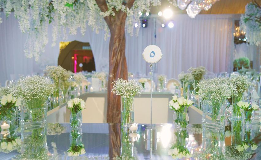 Table numbers and individual mini floral arrangements of baby's breath