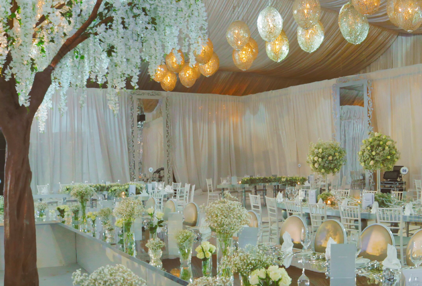 Hanging orbs and low floral arrangement with baby's breath flowers