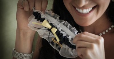 Bride showing off her college team pride with a university of michigan garter