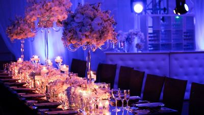 Long rectangular table settings with lush orchids centerpieces