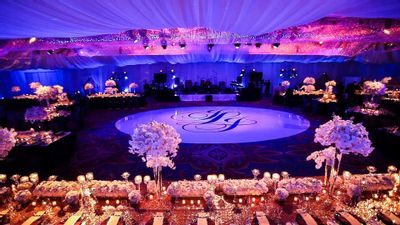 Canopied ballroom decorated with orchids and elegant dance floor