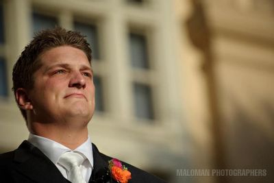 Emotional groom in his Joseph Wendt Custom Clothier watching his bride walk down the aisle