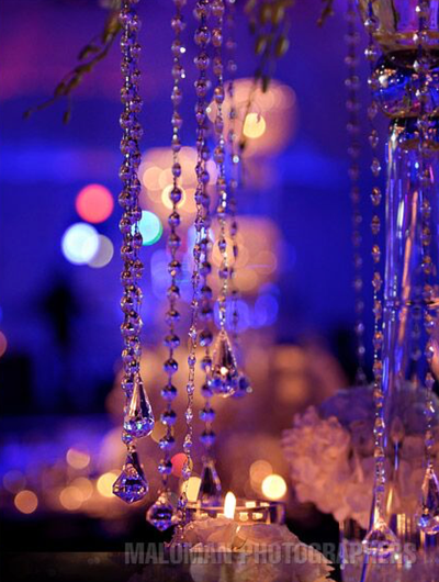 Cascading crystal decorated dinner tables 