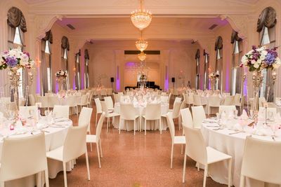 Round dinner tables and white linens at the reception 