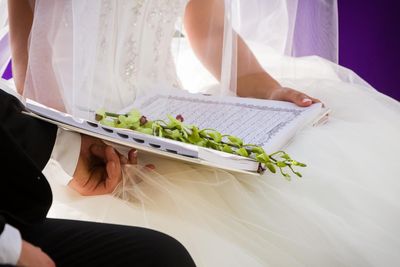 The couple hold their wedding Koran