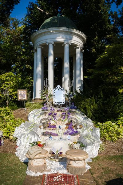 The purple hue Persian sofreh cascading from the tempietto