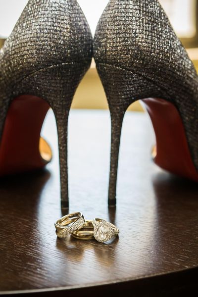 Sparkly wedding heels and couple wedding bands and halo oval shaped engagement ring