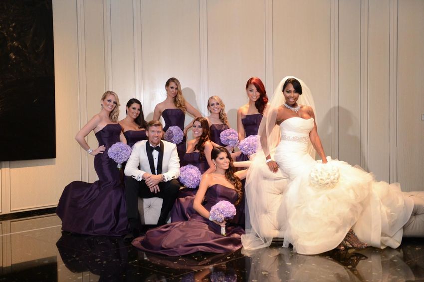 The couple with their bridesmaids in their purple  satin dresses prior the ceremony 