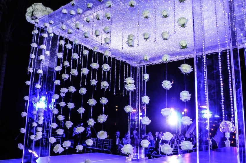 String hanging roses from the mirrored wedding arch