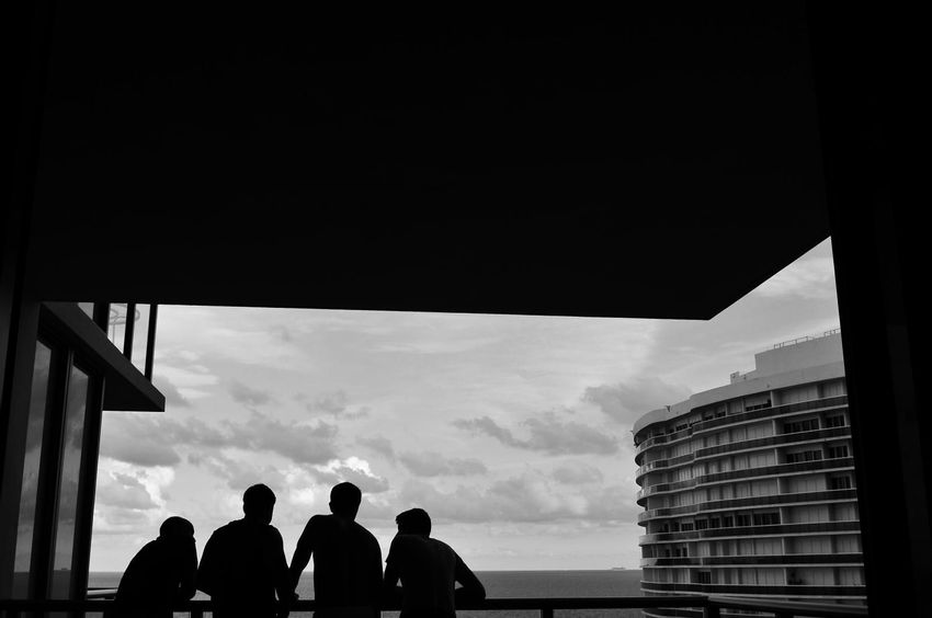 Groom and his groomsmen facing the Miami ocean at The St. Regis Resort, Bal Harbour balcony 