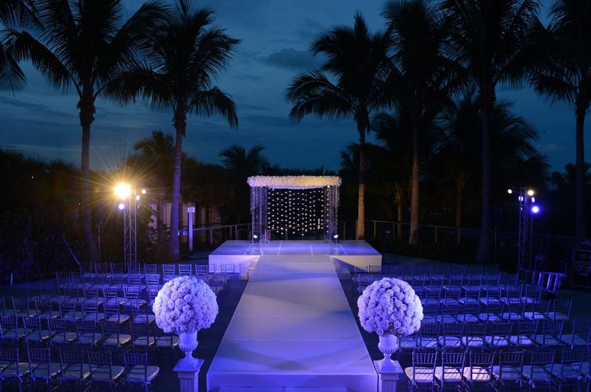 Wedding ceremonial seatting with chiavari chairs under palm trees at The St. Regis Resort, Bal Harbour